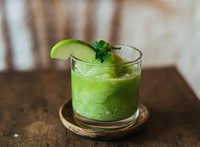 Green apple smoothie on a wooden table