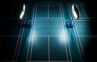 Indoor badminton court with bright white lights