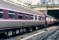 Purple train at a railroad station