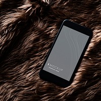 Mobile phone screen mockup on fur surface
