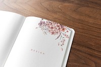 Floral notebook mockup on a wooden table