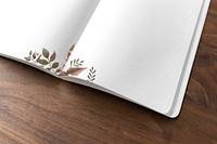 Floral notebook mockup on a wooden table