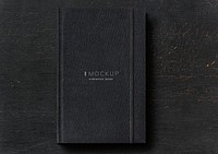 Black notebook mockup on a black table
