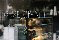 We are open, on a glass wall of a coffee shop