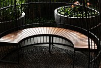 Fenced curved wooden seating in the garden