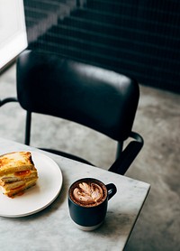 Sandwich and a cup of coffee on a table