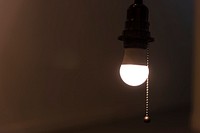 A bright light bulb hanging in a room