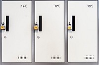 Locked white lockers with padlocks