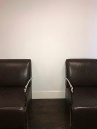 Black leather chairs in a waiting room