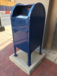 Blue post box on the street