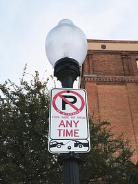 Lamppost with a no parking street sign