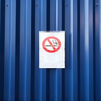 No smoking sign on a blue wall