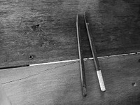 Broken chopstick on a wooden table
