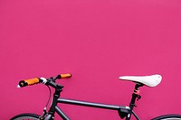 Black city bicycle on pink background