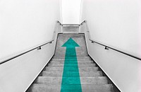 Green arrow on a staircase
