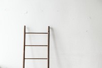 Wooden ladder leaning against a wall