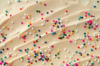 Cake frosting texture background vector with sprinkles on top