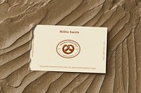 Pastries business card mockup psd on brown frosting texture