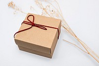 Kraft gift box with red bow rope in minimal style