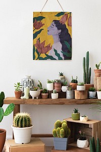 Poster psd hanging over a shelf full of cacti and succulents 