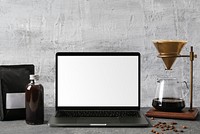 Coffee lover workspace with blank laptop screen