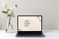 Laptop screen mockup psd, minimal workspace, white flower decoration