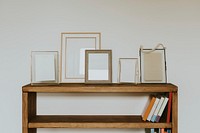 Empty frames on book shelf, natural home decor