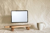 Empty tablet screen, aesthetic wooden shelf 