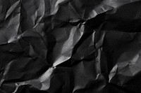Crumpled black paper texture background, design space