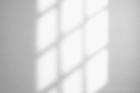 Window light shadow on white wall 