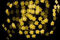 Gold glitter star bokeh sequin confetti on black background