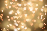 Gold glitter heart bokeh sequin confetti on black background