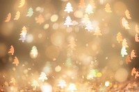 Gold glitter Christmas tree bokeh sequin confetti on black background in warm light 