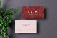 Business card mockup, pink and red design, flat lay with leaf design psd