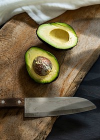Fresh cut avocado on a wooden cutting board