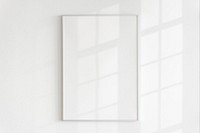 Blank frame on a wall with natural light