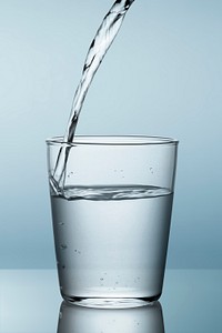 Macro shot of pouring water into a glass