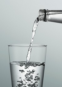 Macro shot of pouring water into a glass