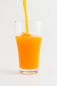 Pouring fresh organic orange juice into a glass