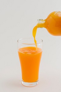 Pouring fresh organic orange juice to a glass