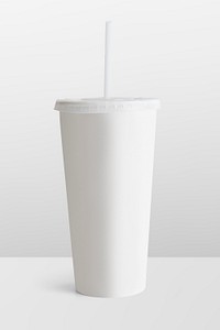 White disposable cup with a plastic lid and a straw 