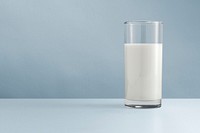 Fresh milk in a glass on blue background mockup