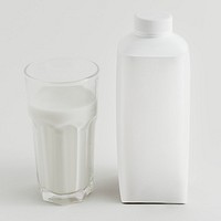 Fresh milk in a glass with a bottle