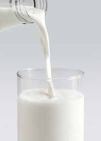 Close up of pouring milk into a glass