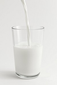 Close up of fresh milk poring into a glass