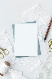 Blank white card on a white lace roll