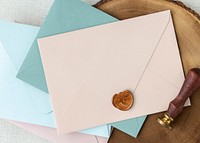 Blue and pink envelopes on a wooden plate