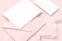 Blank card and envelope on a pink background