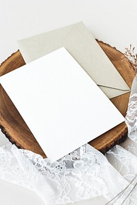 Blank white card on a wooden plate