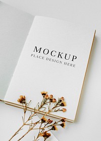 White notebook template mockup with dried plant